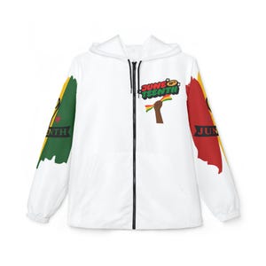 May include: White zip-up hooded jacket with colorful graphics. The jacket features the text "June 19th" with a raised fist holding a banner. The sleeves have green, yellow, and red brushstroke designs with the word "June" on them.