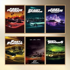 May include: Six framed movie posters from the Fast & Furious film franchise. The posters feature images of cars, cityscapes, and the film titles. The color palette includes red, blue, green, and purple.