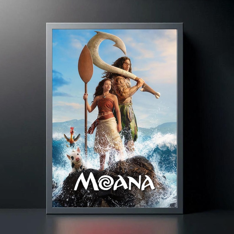 May include: A framed movie poster for the animated film "Moana." The poster features two main characters standing on a rock in the ocean, with a large hook and a paddle. The title "Moana" is displayed in white text.