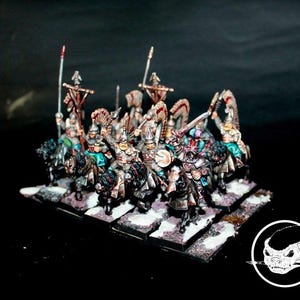 May include: Miniature figurines of mounted soldiers in ornate armour, holding spears and swords. The figures are painted with detailed colours and mounted on black horses. The base is a rectangular platform with a snowy effect.