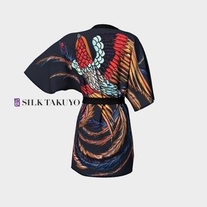 May include: A black silk robe with a colorful phoenix design. The robe has a black sash and is tied at the waist. The phoenix is depicted in flight with its wings spread wide. The robe is made of high-quality silk and is perfect for lounging or special occasions.