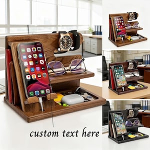 May include: A wooden desk organizer with multiple compartments. It features a slot for a smartphone, a shelf for glasses, and a tray for small items. A watch and a smart watch are displayed on the top. The organizer is made of dark wood.