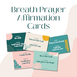 May include: A collection of affirmation cards with the text "Breath Prayer Affirmation Cards." Each card features inspirational phrases like "Be still" and "You are the God," with floral and geometric designs in pastel colors.