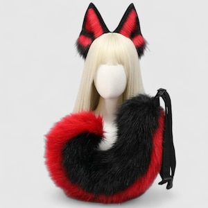 May include: A cosplay set featuring a pair of red and black fox ears and a matching tail. The ears are black-tipped and the tail is red-edged. The set is designed to be worn as a costume accessory.