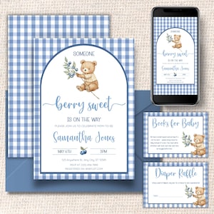May include: Baby shower invitation set with a blue gingham pattern. The invitation features a watercolor illustration of a teddy bear holding berries, with the text "berry sweet" and event details. Includes a phone mockup and inserts.