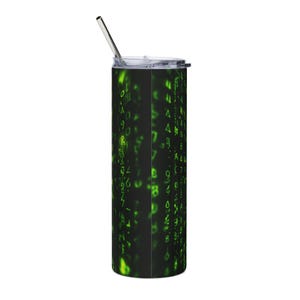 May include: A tall, cylindrical stainless steel tumbler featuring a black background with a digital pattern of glowing green numbers and symbols cascading vertically. The tumbler includes a clear plastic lid and a thin, straight metal straw.