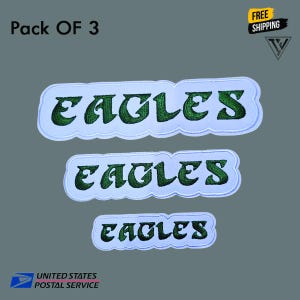 May include: Three embroidered patches with the word "EAGLES" in green, outlined in white, and set against a light blue background. The patches are in different sizes. The words "Pack OF 3" and "FREE SHIPPING" are also visible.