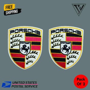 May include: Two embroidered Porsche patches. Each patch features the Porsche logo with the word "PORSCHE" at the top, a black and red striped section, and a crest with a black horse. The patches are on a gray background.