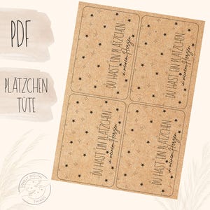 May include: A sheet of kraft paper labels with a star pattern and the text "DU HAST EIN PLATZCHEN in meinem Herzen". The labels are rectangular with rounded corners. The words "PDF" and "PLATZCHEN TUTE" are also visible.