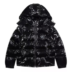 May include: A glossy black puffer jacket with a hood and a full-length zipper. The jacket has a shiny, reflective surface and a small logo on the chest. The jacket is designed for cold weather.