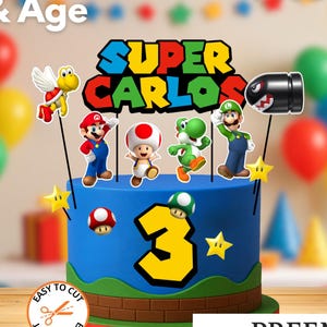 May include: A blue birthday cake with a yellow number 3 and Super Mario characters. The cake has a green and brown base, with star and mushroom decorations. The text "SUPER CARLOS" is on top, with the words "Name & Age" and "PNG" above the cake.