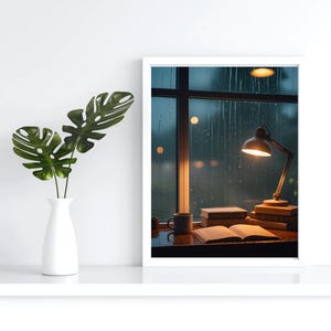 May include: A framed print depicts a cozy indoor scene. A lit desk lamp illuminates a stack of books and an open book. A mug sits nearby. Outside the window, rain falls. A white vase holds green leaves.