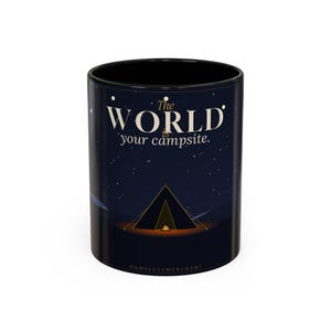 May include: Black ceramic mug with a night sky design. The mug features the text "The World is your campsite" in white, with a tent illustration. The bottom of the mug has the text "HOMELESSMERCHANT".