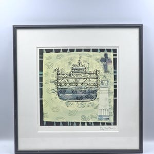 May include: Framed abstract art print featuring a central vessel-like shape in black and blue, set against a pale green background with wave patterns. The artwork includes geometric and linear elements, framed in a black border.