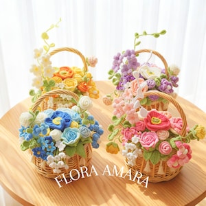 May include: Four woven wicker baskets filled with crocheted flowers in various colours including yellow, orange, blue, white, pink, and purple, with green crocheted leaves and vines. The text FLORA AMARA is printed in white at the bottom centre.