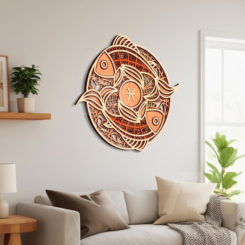 May include: A layered wooden wall art piece featuring the Pisces zodiac symbol. The design includes two fish in a circular pattern, with the Pisces symbol in the center. The artwork is made of light brown and orange wood, creating a 3D effect.