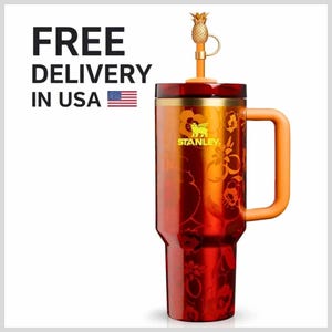May include: A tall, cylindrical Stanley tumbler in a deep red finish with an orange floral pattern. It features a gold-toned rim, a matching orange handle, and a lid topped with a small, gold-colored pineapple-shaped straw topper.