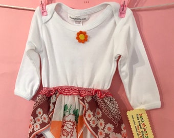 A sweet Baby girl onesie with a vintage hanky skirt, pretty apricot flowers with a pale brown. Baby one piece, instant dress up!