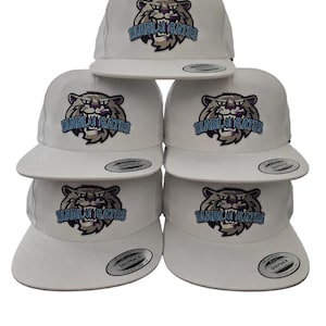 May include: A stack of five white snapback caps, each featuring an embroidered graphic of a snarling cat face with purple and light blue accents. The text DIABLO GATOS is stitched below the cat graphic on the front panel of every hat.