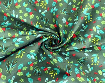 May include: Dark green fabric with a repeating pattern of stylized holly leaves and berries. The leaves are in shades of green and teal, with red berries and yellow accents. The fabric is gathered in a swirl.
