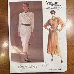 May include: A vintage Vogue Patterns sewing pattern by Calvin Klein, featuring illustrations of two dresses. The pattern includes the text "AMERICAN DESIGNER" and "PATTERN/PATRON 1793".