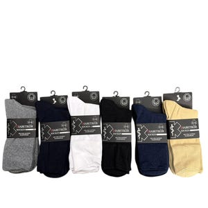 May include: A display of six pairs of diabetic socks in various colors: gray, navy, white, black, dark blue, and tan. Each pair is packaged with a black hanger and a label featuring a medical symbol and the text "DIABETIKER SOCKEN".