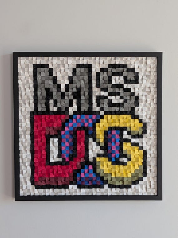 Hand-crafted wooden pixel mosaic of the MS-DOS logo — each 'pixel' is an individual piece of wood, turning 80s computing nostalgia into genuine wall art.