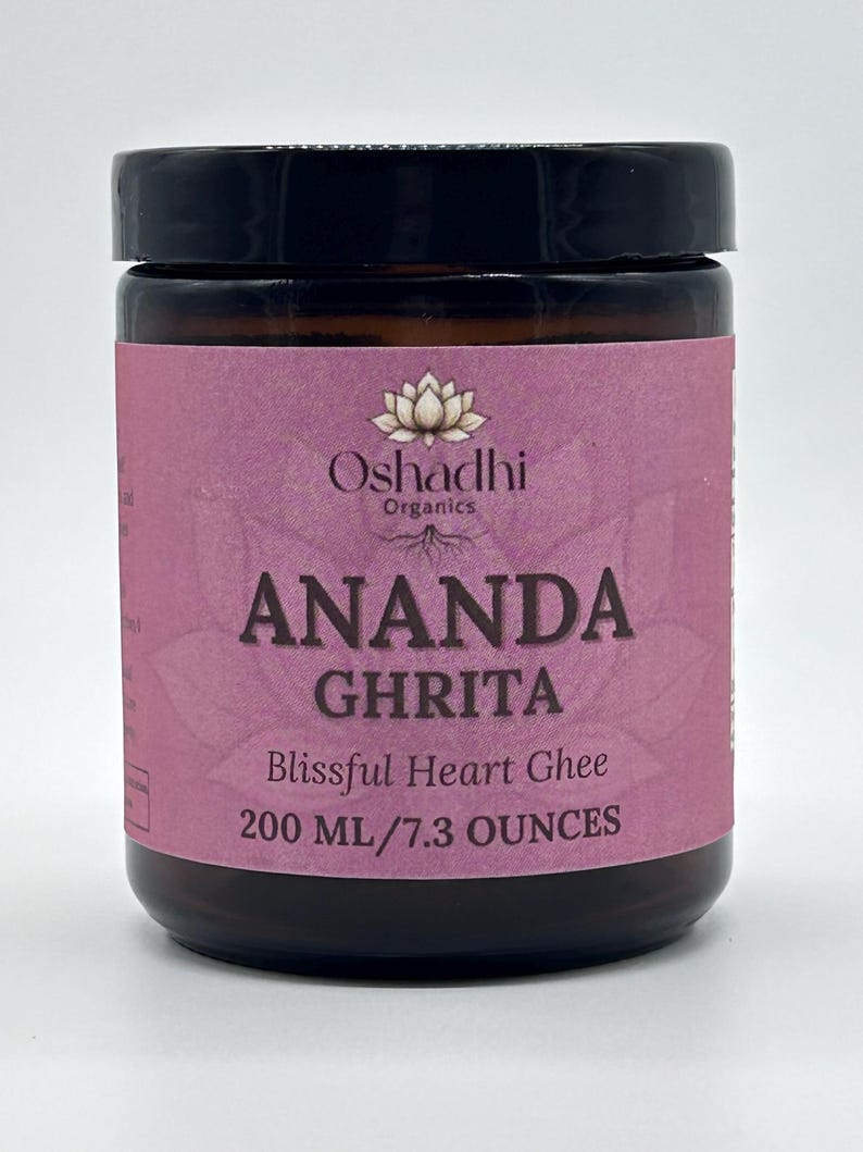May include: A brown jar of Ananda Ghrita ghee with a black lid and a pink label. The label reads "Oshadhi Organics" and "ANANDA GHRITA Blissful Heart Ghee 200 ml/7.3 OUNCES". The jar is filled with a golden substance.