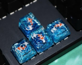 Teclas de flecha de resina hechas a mano con diseño de pez koi azul, teclas WASD para teclado mecánico con temática oceánica.
