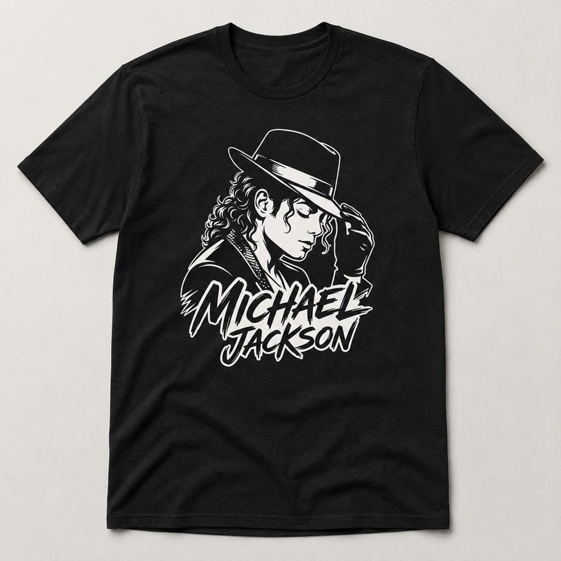 May include: Black t-shirt featuring a white graphic of Michael Jackson in a hat, with the text "MICHAEL JACKSON" below the image. The design is a stylized illustration of the singer.