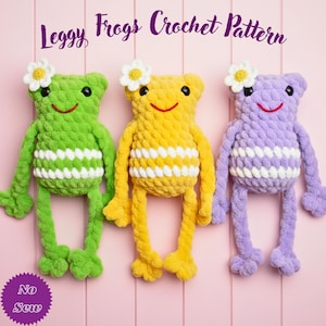 May include: Three handmade crochet frog toys in green, yellow, and purple, each with a white and cream striped belly, long legs, and a daisy on their head. The text "Leggy Frogs Crochet Pattern" is at the top.