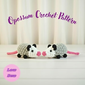 May include: Two crocheted opossums with gray bodies, white faces, pink noses, and pink tails. The text "Opossum Crochet Pattern" is above the opossums. The text "Low Sew" is in a pink circle below the opossums.