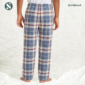 May include: Blue, cream, and burgundy plaid pajama pants. The pants have an elastic waistband and a relaxed fit. The Sewmood logo is visible in the upper right corner. The pants are made of a soft, comfortable fabric.