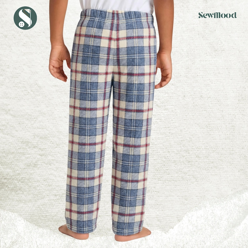 May include: Blue, cream, and burgundy plaid pajama pants. The pants have an elastic waistband and a relaxed fit. The Sewmood logo is visible in the upper right corner. The pants are made of a soft, comfortable fabric.