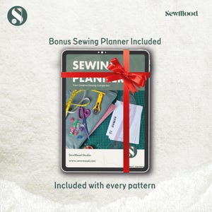 May include: A tablet wrapped with a red ribbon, featuring a sewing planner with sewing tools. The text reads "Bonus Sewing Planner Included" and "Included with every pattern". The planner includes a measuring tape, scissors, and fabric.