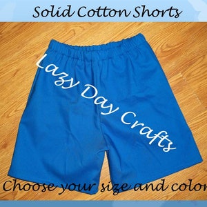 May include: Solid cotton shorts in a bright blue color. The shorts have a drawstring waistband and are made by Lazy Day Crafts. The text "Choose your size and color" is at the bottom of the image.