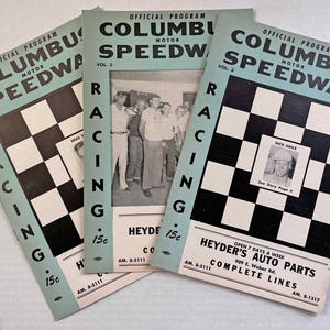May include: Three vintage Columbus Speedway racing programs. The covers are light blue with black and white checkered flags and the text "COLUMBUS SPEEDWAY" and "RACING". One program features a photo of a group of people, and another features a photo of Dick Grice.