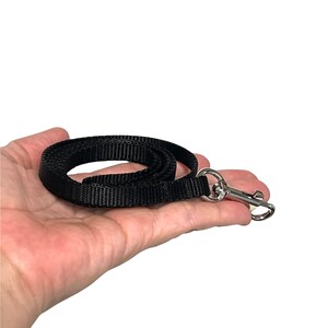May include: A black nylon lanyard with a silver swivel hook.