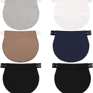 May include: Six belly extenders in various colors: gray, white, brown, navy blue, and two black. Each extender has a rounded bottom and a top section with adjustable button or hook closures for pants or skirts.