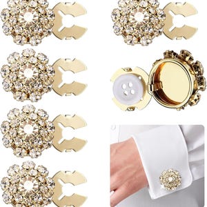 May include: Gold-toned, rhinestone-studded cufflink sets. The cufflinks feature a central, large rhinestone surrounded by smaller stones. One cufflink has a button attachment. The image also shows a person wearing a cufflink.