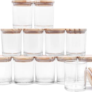 May include: A collection of clear glass jars with wooden lids. The jars are cylindrical and appear to be empty. The lids are made of light-colored wood. The jars are arranged in a neat, organized display.