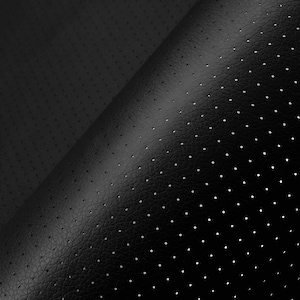 May include: Close-up of black perforated leather. The material has a textured surface with small, evenly spaced holes. The leather is folded, revealing the underside and highlighting the texture and pattern. The lighting creates shadows and emphasises the details.