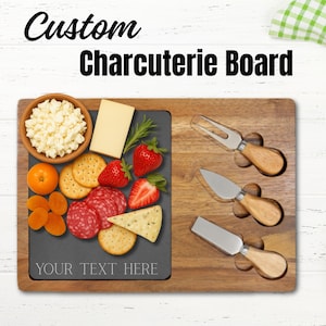 May include: A wooden charcuterie board with a dark gray slate insert. The board is filled with cheese, crackers, fruit, and salami. The text "Custom Charcuterie Board" and "YOUR TEXT HERE" are visible.