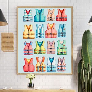 May include: A framed print featuring a collection of colorful life jackets. The watercolor illustrations showcase various designs in shades of red, blue, yellow, and green. The life vests are arranged in a grid pattern against a light blue background, perfect for nautical decor.