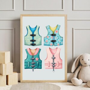 May include: A framed print featuring four watercolor illustrations of life vests. The vests are in shades of blue, green, and pink, with details like buckles and zippers. Some vests have floral patterns.