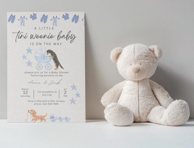 May include: A baby shower invitation card featuring blue baby clothes, a dog with a baby carriage, and a dachshund pulling ducks, alongside a beige plush teddy bear. The text reads A LITTLE Tini weenie baby IS ON THE WAY, Anna & Jack, and event details.