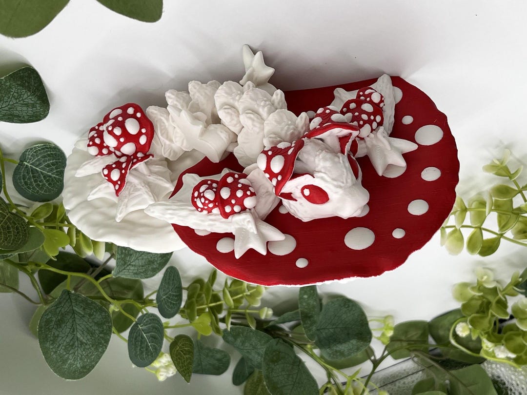 Amanita mushroom wall shelf with a little dragon curled on the red-and-white cap