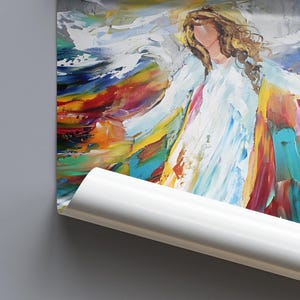 May include: Abstract painting of a figure with flowing white robes and long, wavy blonde hair. The artwork features vibrant brushstrokes in shades of red, yellow, blue, and green, creating a colorful and dynamic composition. The painting is partially rolled.