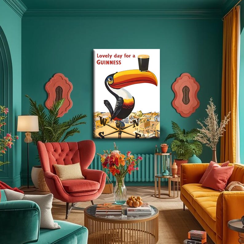 May include: A framed print featuring a toucan with a Guinness pint on its beak. The artwork includes the text "Lovely day for a Guinness" and a cityscape background. The toucan has a large orange and yellow beak, black body, and white chest.