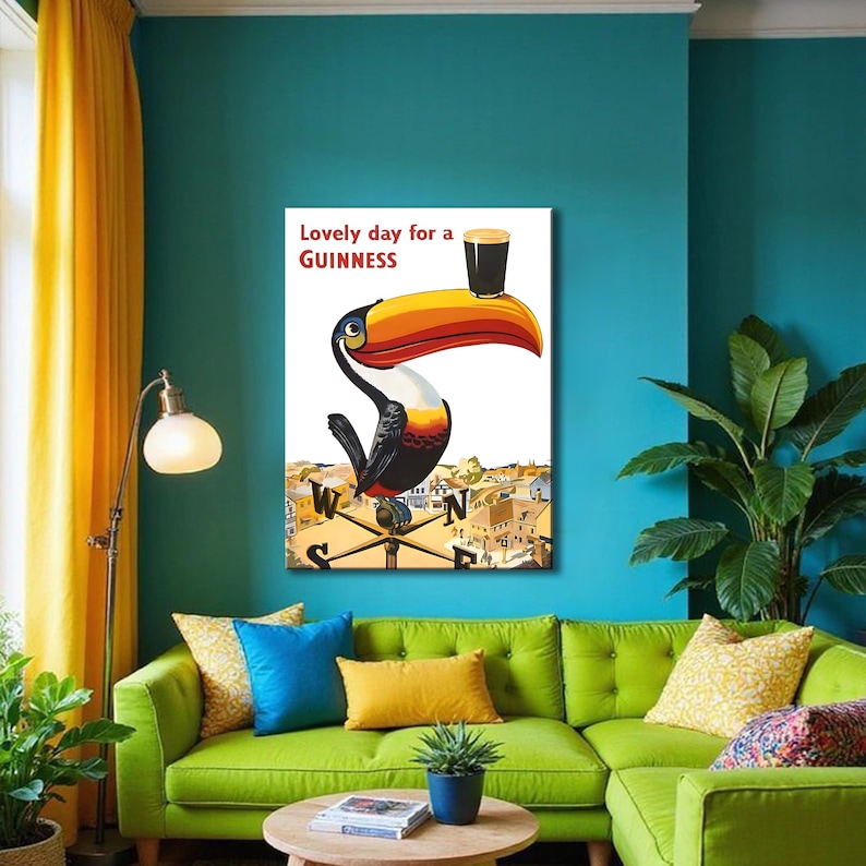 May include: A framed print featuring a toucan with a Guinness pint balanced on its beak. The toucan is set against a backdrop of a town and a weather vane. The text "Lovely day for a Guinness" is displayed at the top. The artwork has a vintage, advertising style.
